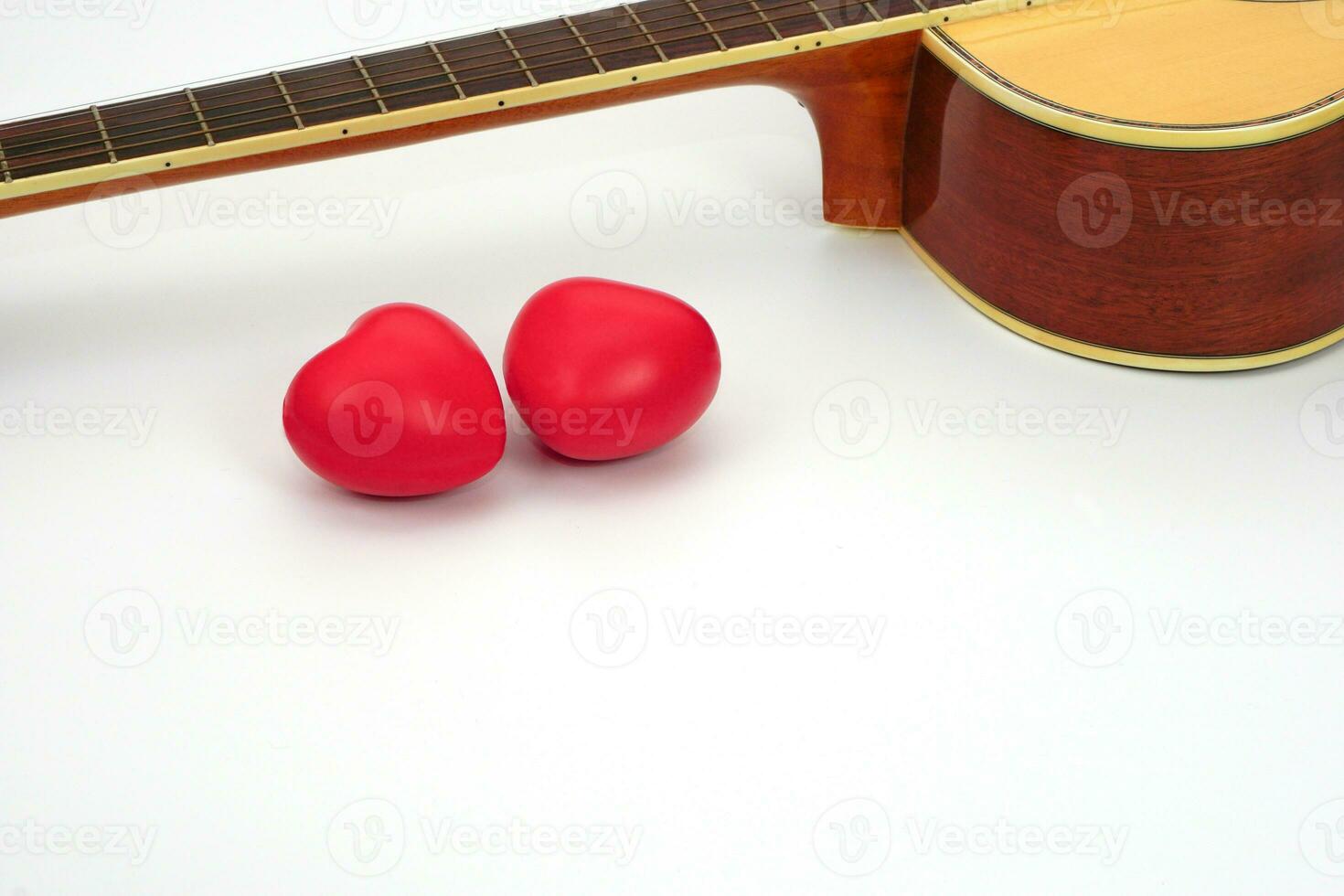 akustisk gitarr nacke och röd hjärta mot vit bakgrund. kärlek, koppla av och musik begrepp. foto