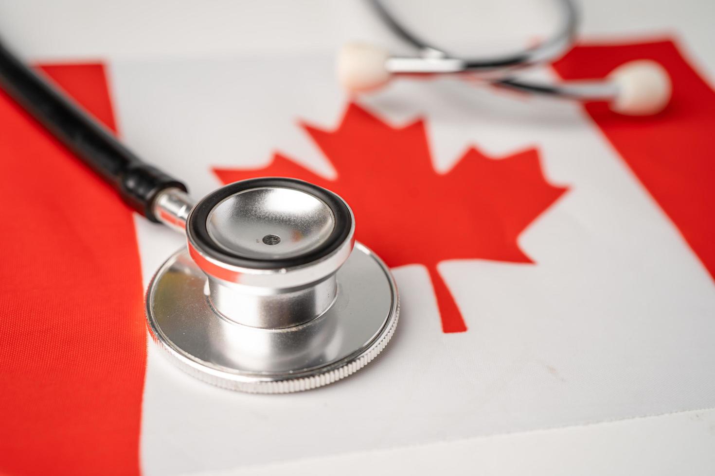 svart stetoskop på Kanada flaggabakgrund, affärs- och finansbegrepp. foto