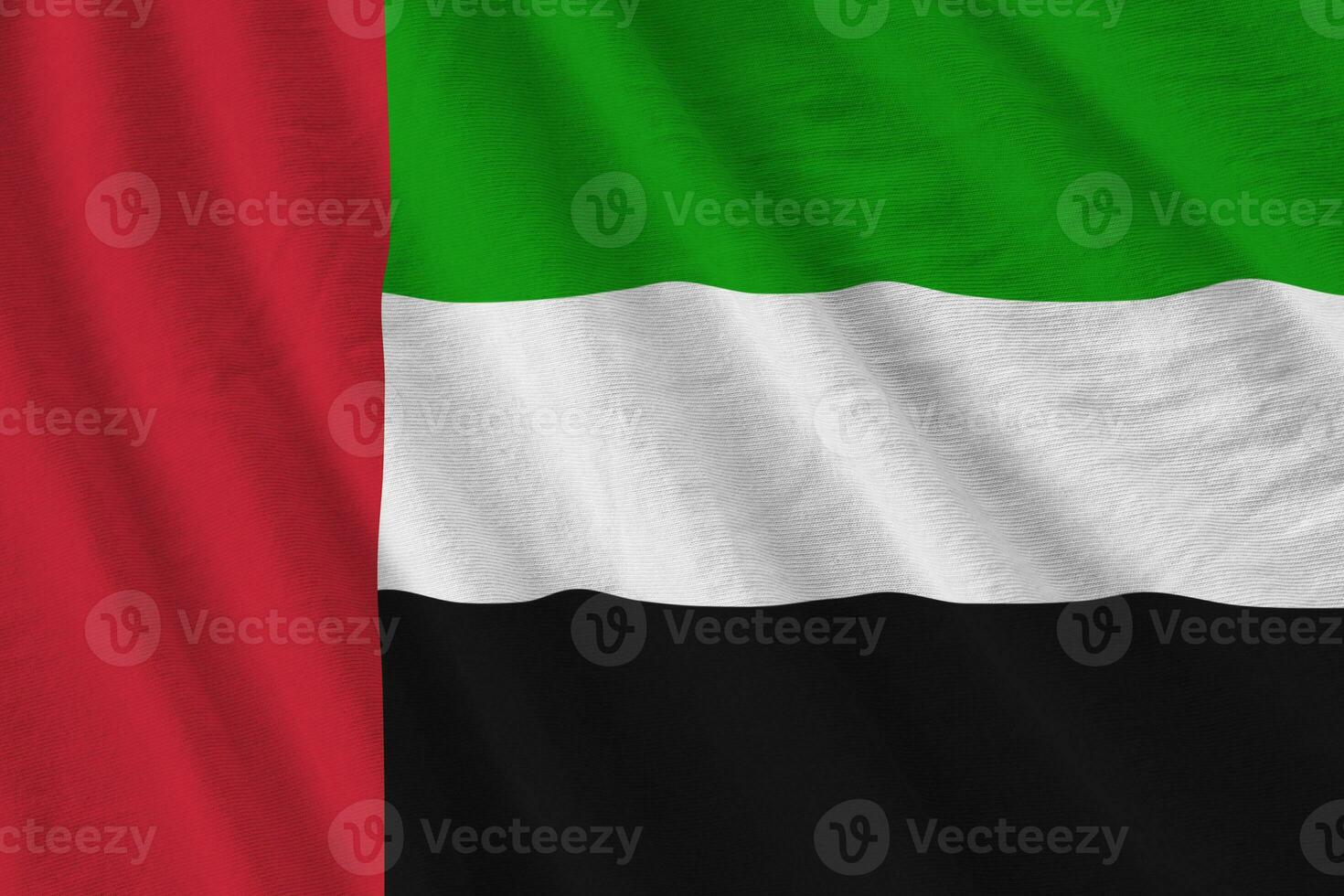 förenad arab emirates flagga med stor veck vinka stänga upp under de studio ljus inomhus. de officiell symboler och färger i baner foto
