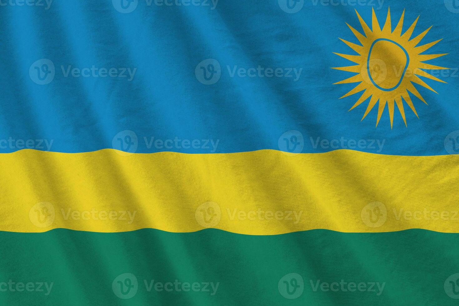 rwanda flagga med stor veck vinka stänga upp under de studio ljus inomhus. de officiell symboler och färger i baner foto