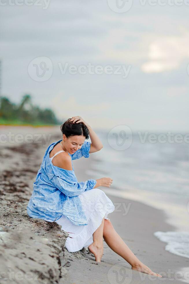 Lycklig kvinna på de strand semester foto