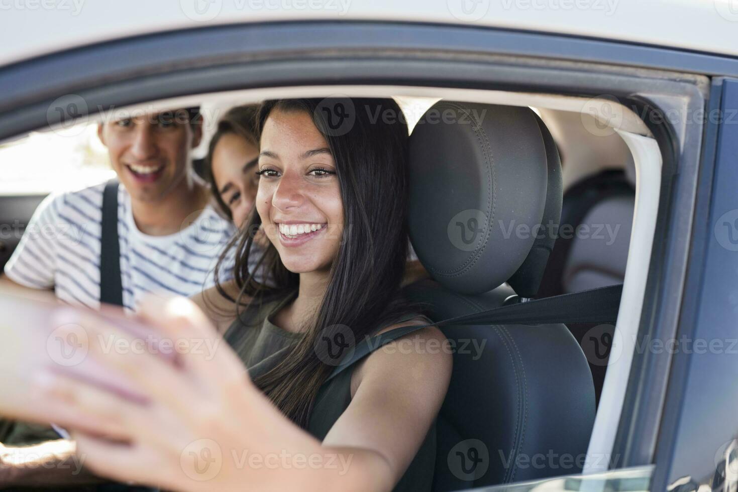 vänner har roligt på en väg resa, tar smartphone selfies foto