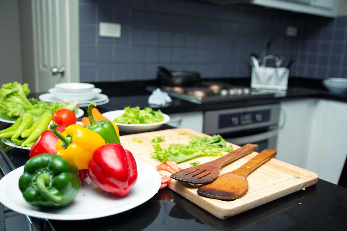 asiatisk kvinna ung mamma med son pojke matlagning sallad foto