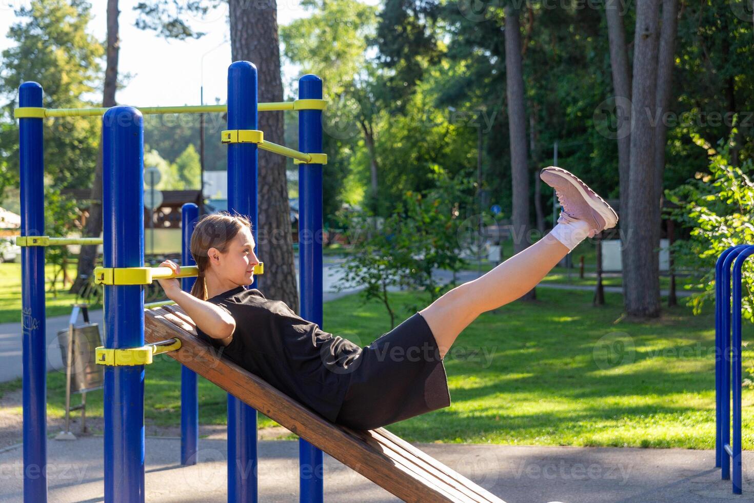 en Tonårs flicka håller på med abdominal crunches. foto