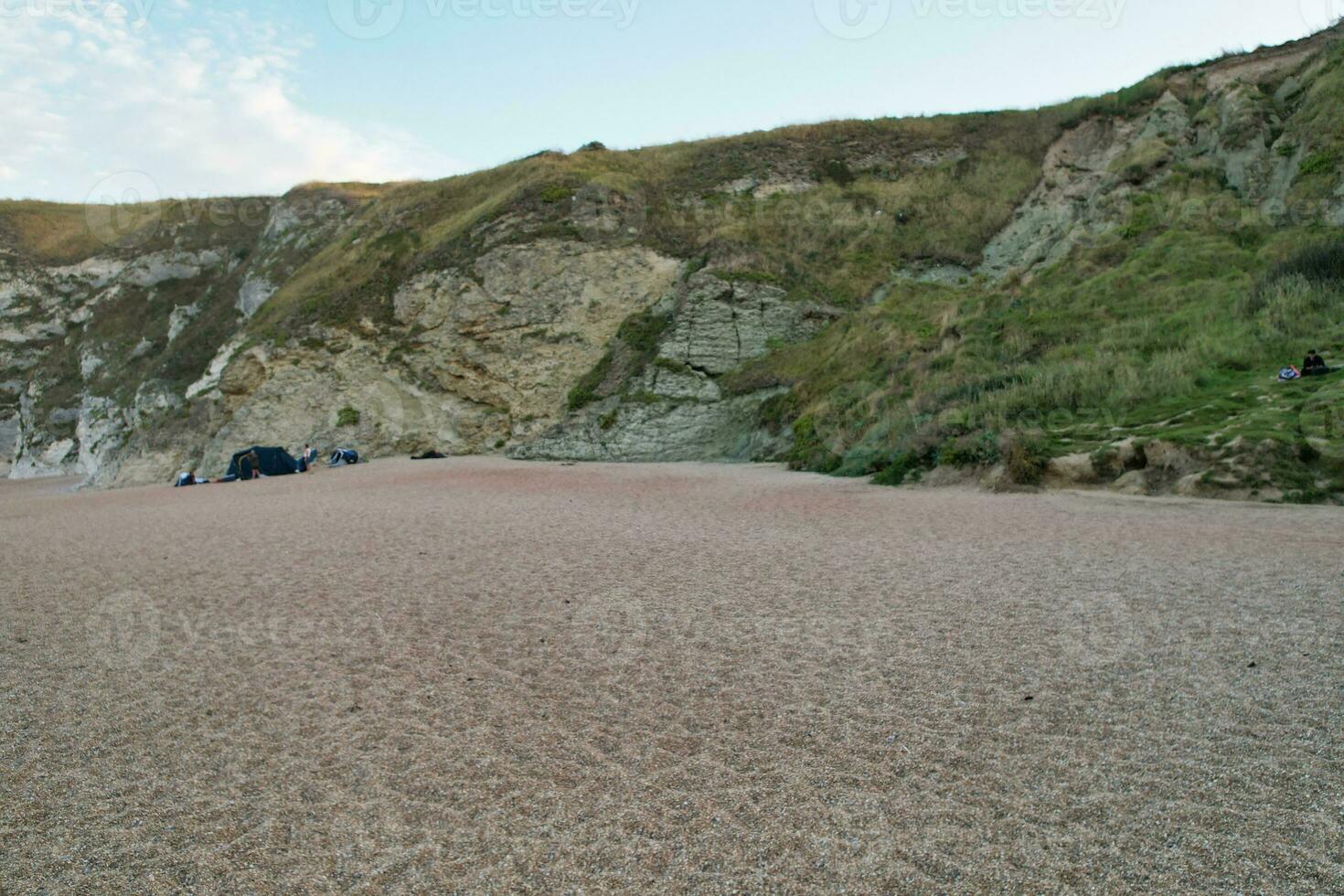 hög vinkel se av människor är närmar sig till durdle dörr strand som är mest känd turist attraktion plats genom gående distans över landskap och kullar. fångad på september 9:e, 2023 foto