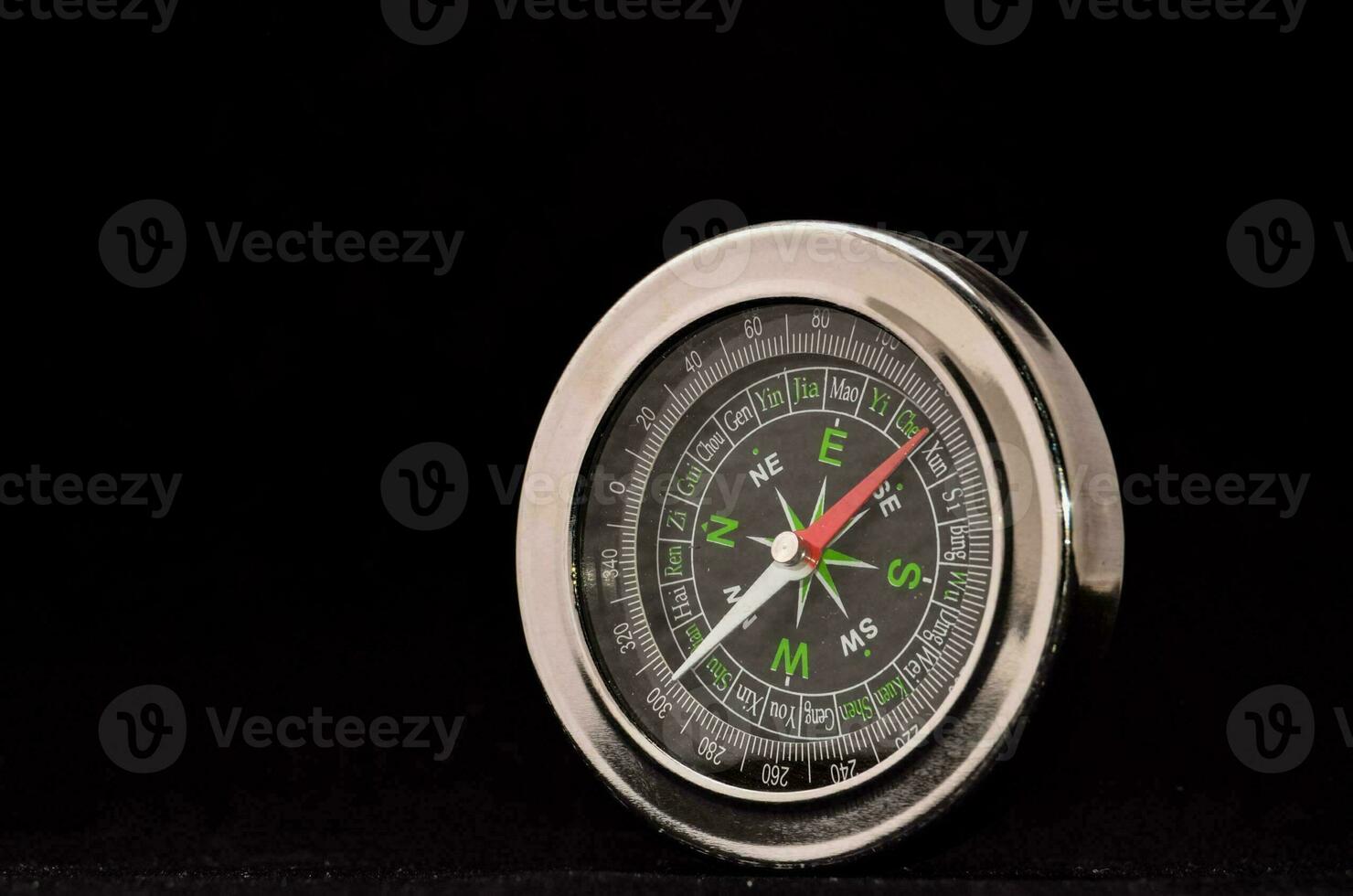 en silver- kompass på en svart bakgrund foto