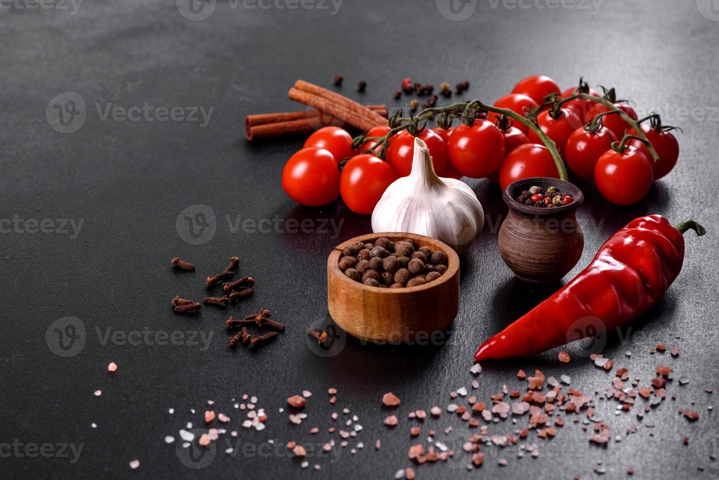 ingredienser för matlagning, kryddor, vitlök, tomater och örter foto
