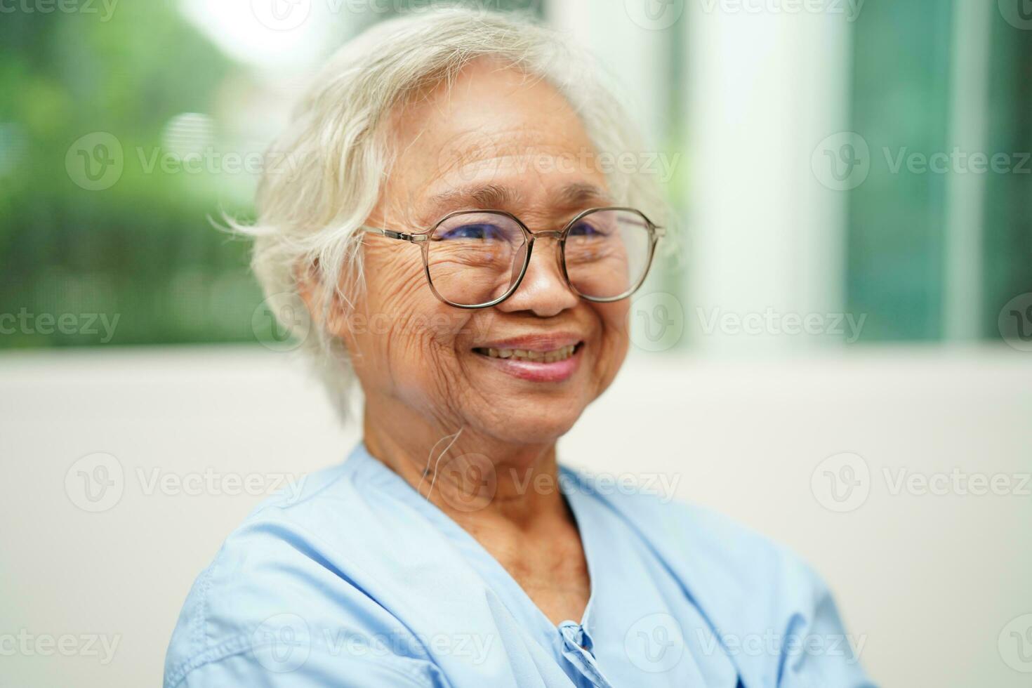asiatisk senior kvinna bär glasögon eller syn glasögon på Hem vård service. foto