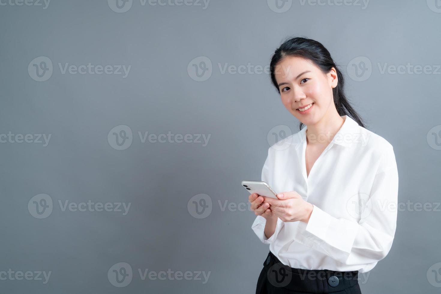 asiatisk kvinna som använder mobiltelefonapplikationer foto