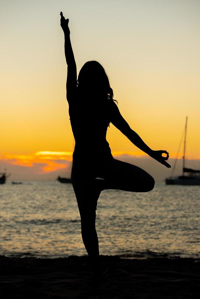 kvinna som övar yoga på stränderna i formentera i Spanien foto