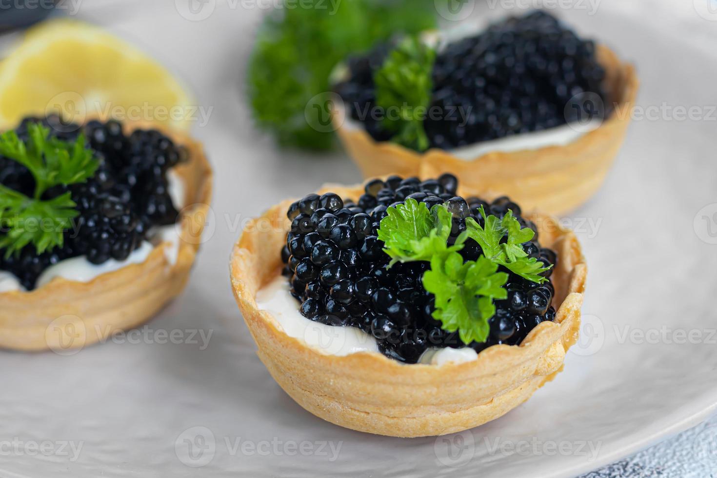 svart kaviar i tårtor på en ljus bakgrund. hälsosam mat koncept. foto