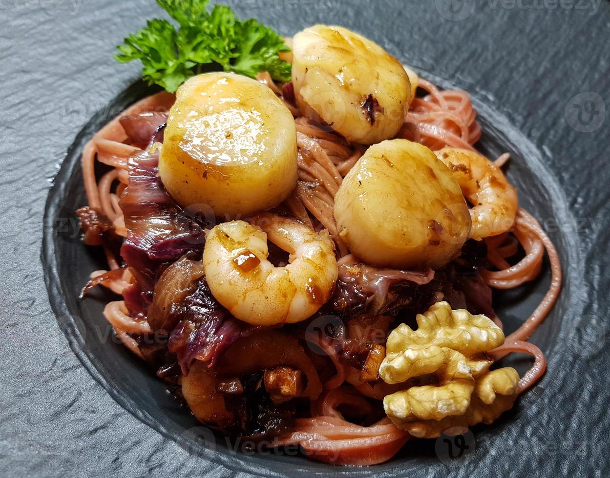 pilgrimsmusslor med röda linguine pasta örter och kryddor foto