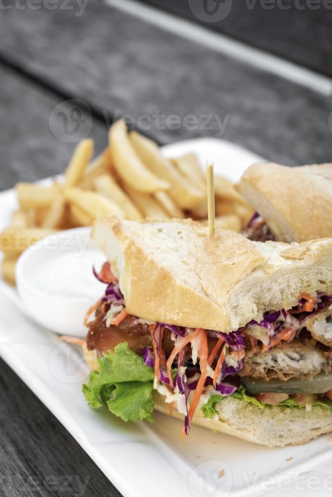 stekt misshandlad färsk fiskfilésmörgås med coleslaw sallad pommes frites och tartarsås foto