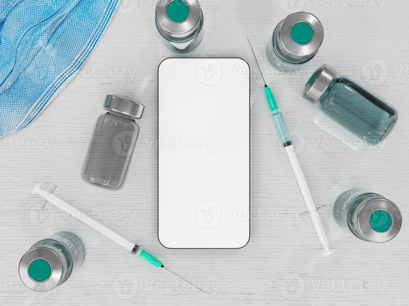 mobiltelefon med vacciner och sprutor foto