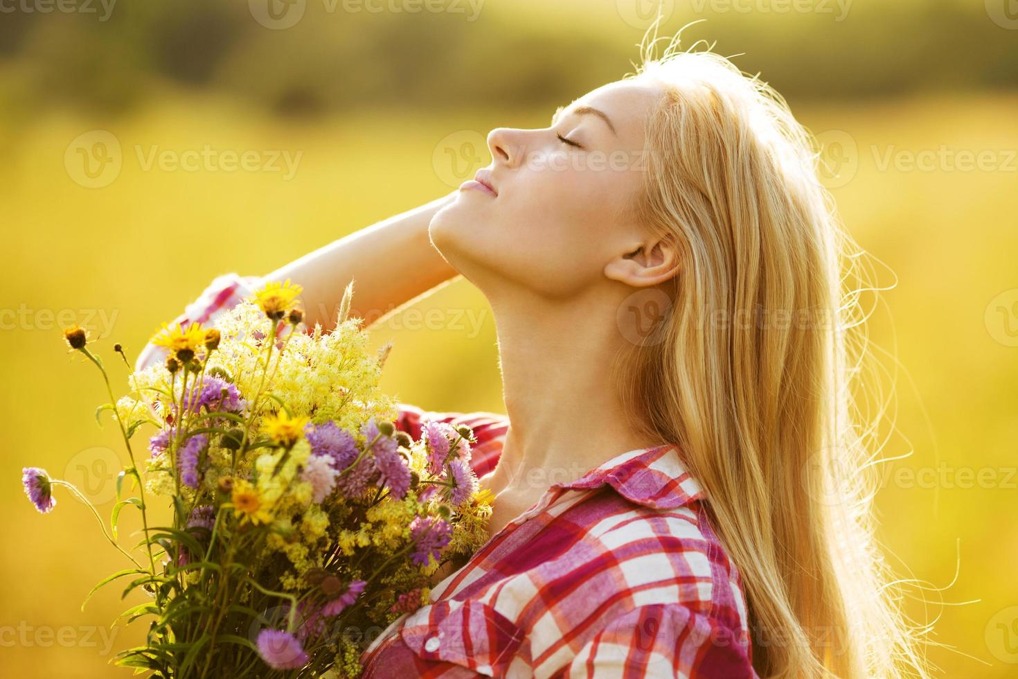 glad tjej med en bukett vackra blommor foto