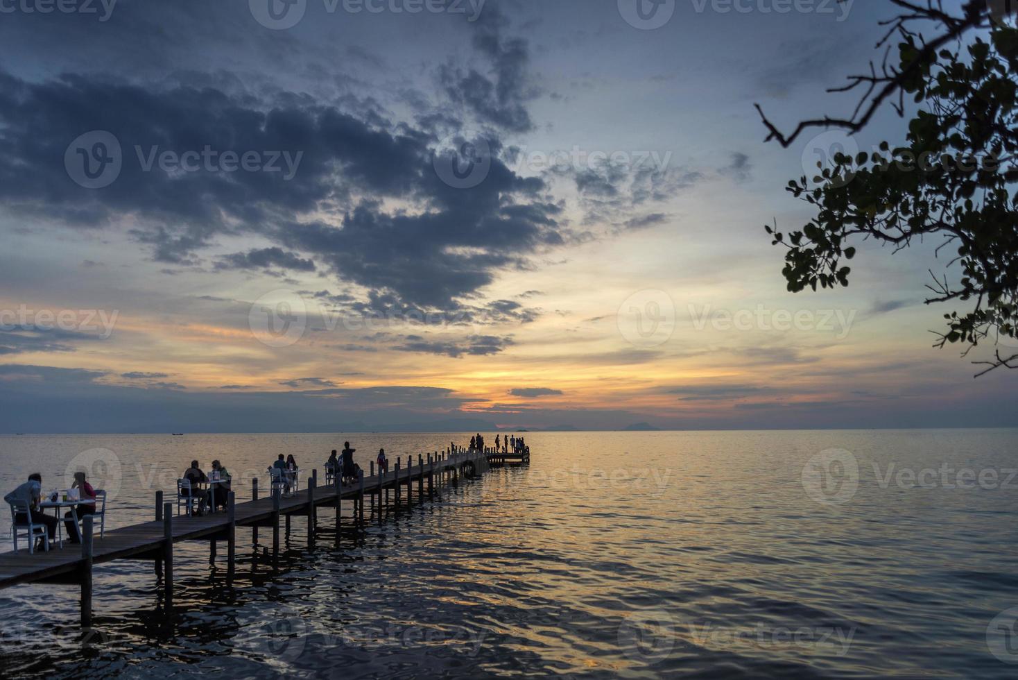 turister ser solnedgången vid piren i Kep Town på Kambodjas kust foto