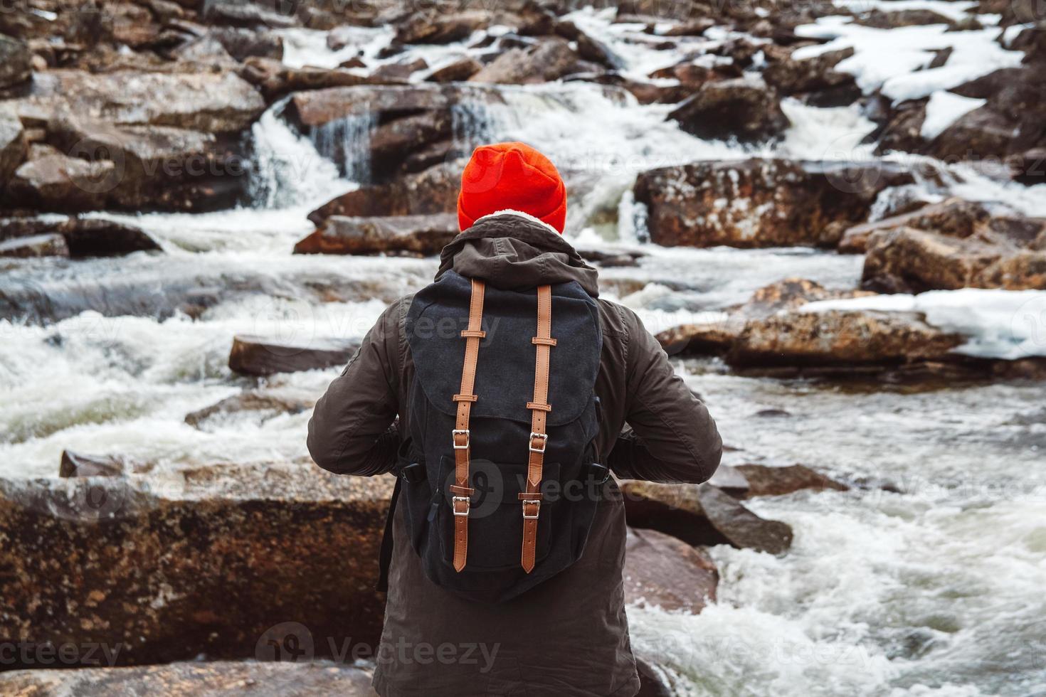 resenär man står på en klippa på berget floden och vattenfall foto