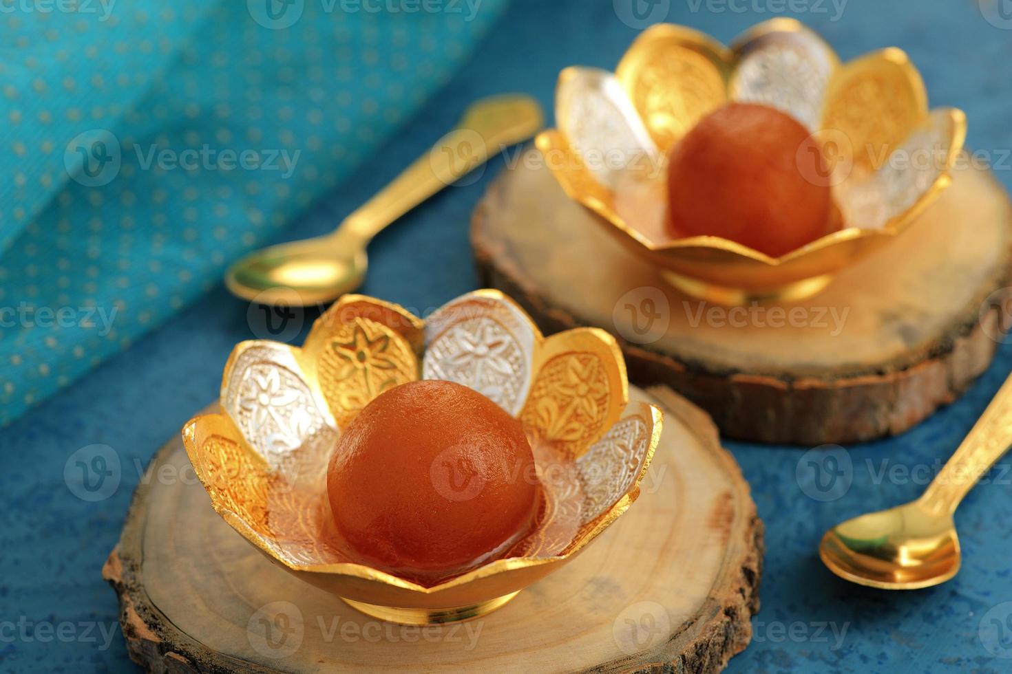 indisk sötmat gulab jamun i en traditionell metallskål foto