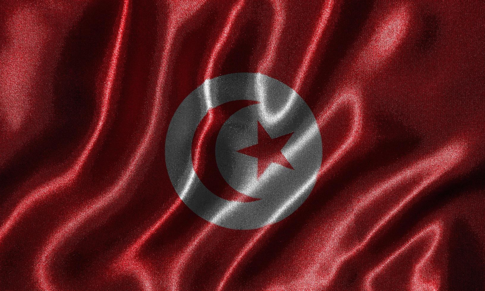 tapeter av tunisiens flagga och viftande flagga av tyg. foto