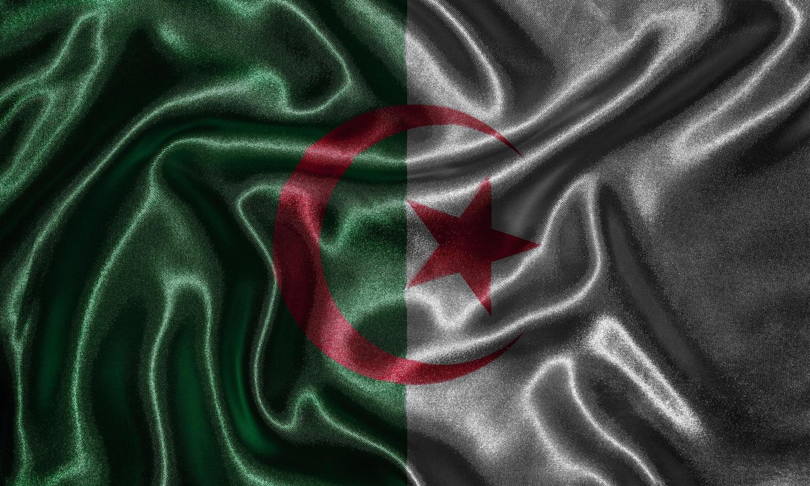 tapet av algeriens flagga och viftande flagga efter tyg. foto