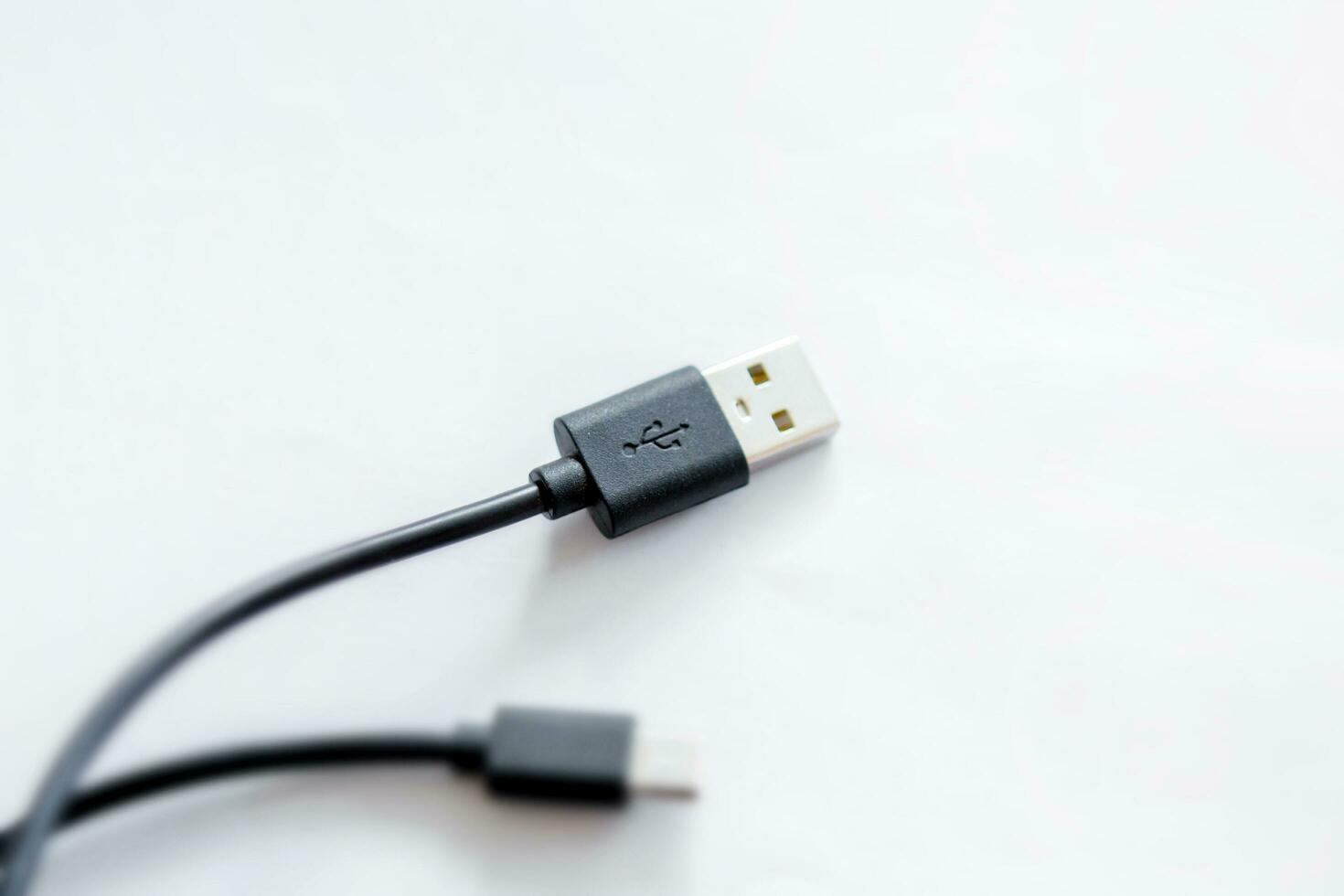 närbild av svart uSB laddning kabel, kompatibel för många enheter, isolerat på vit bakgrund. foto