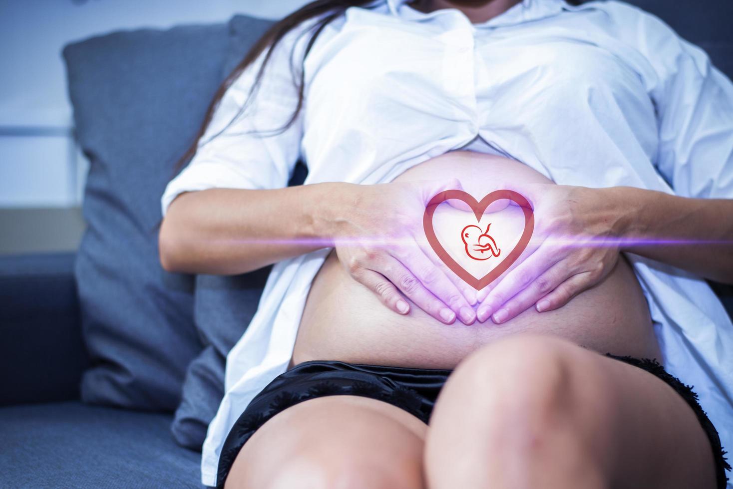 gravid kvinna med baby illustration i hjärtform foto