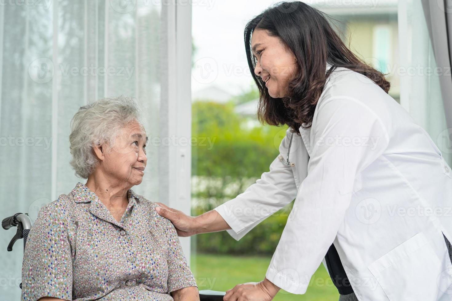 asiatisk läkare hjälp asiatisk äldre kvinna patient på sjukhus. foto