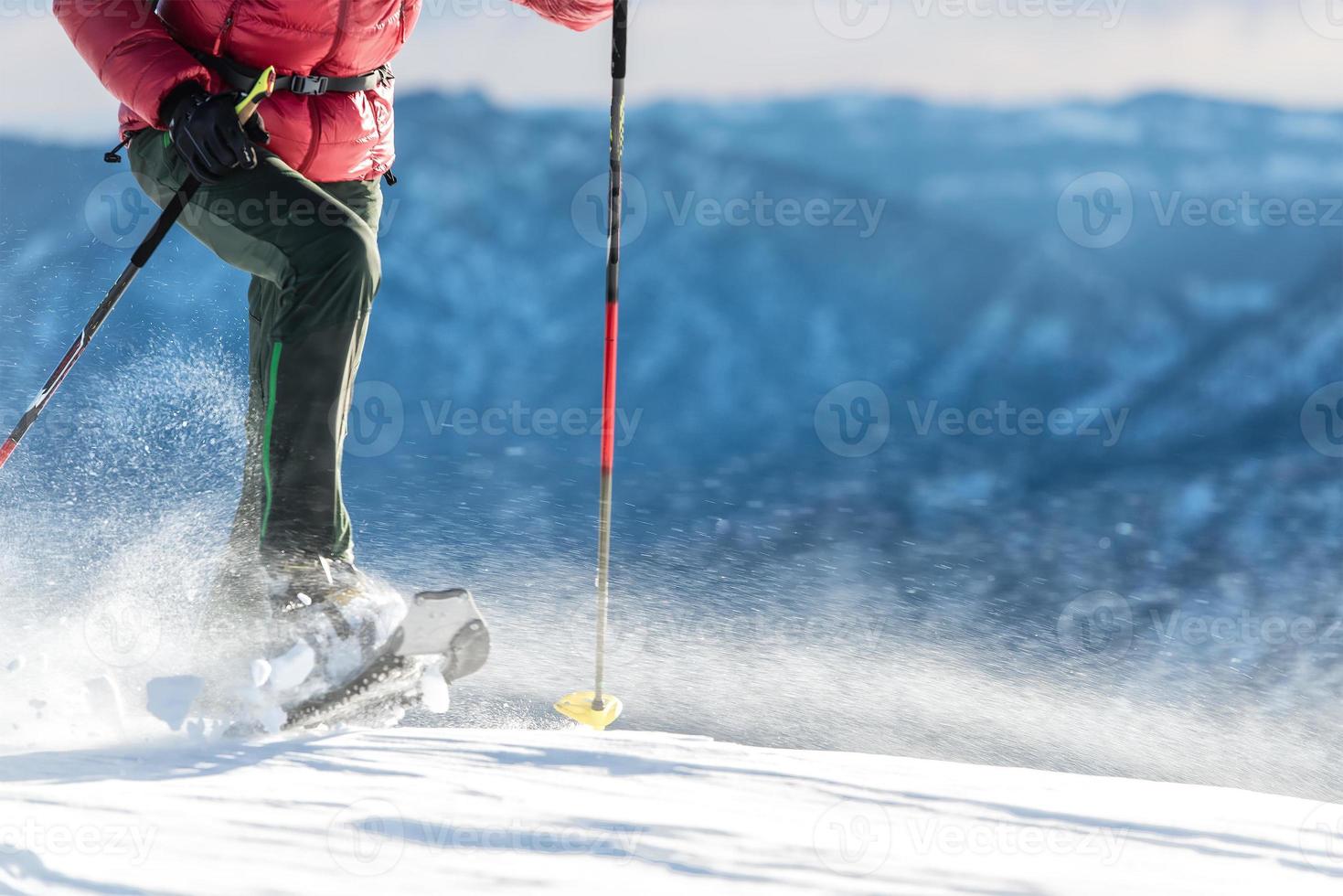 gå med snöskor på en blåsig dag foto