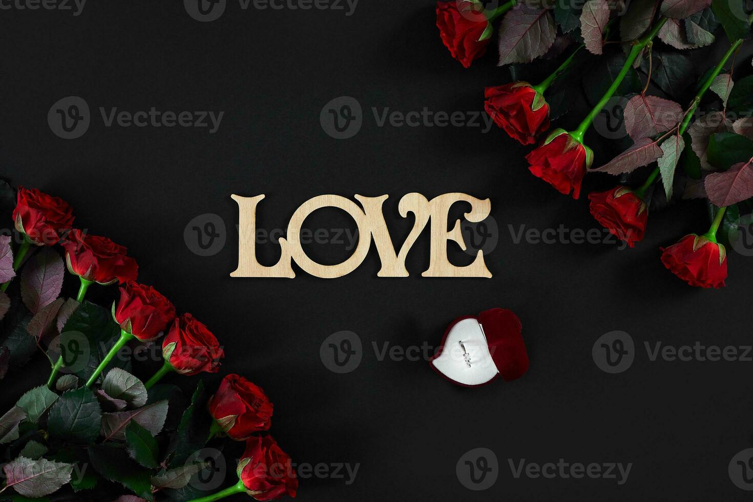 röd ro blommor med trä- ord kärlek på svart bakgrund med foto