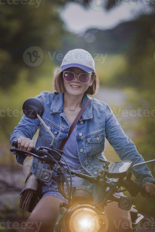 Söt kvinna ridning sport enduro motorcykel på smuts fält foto