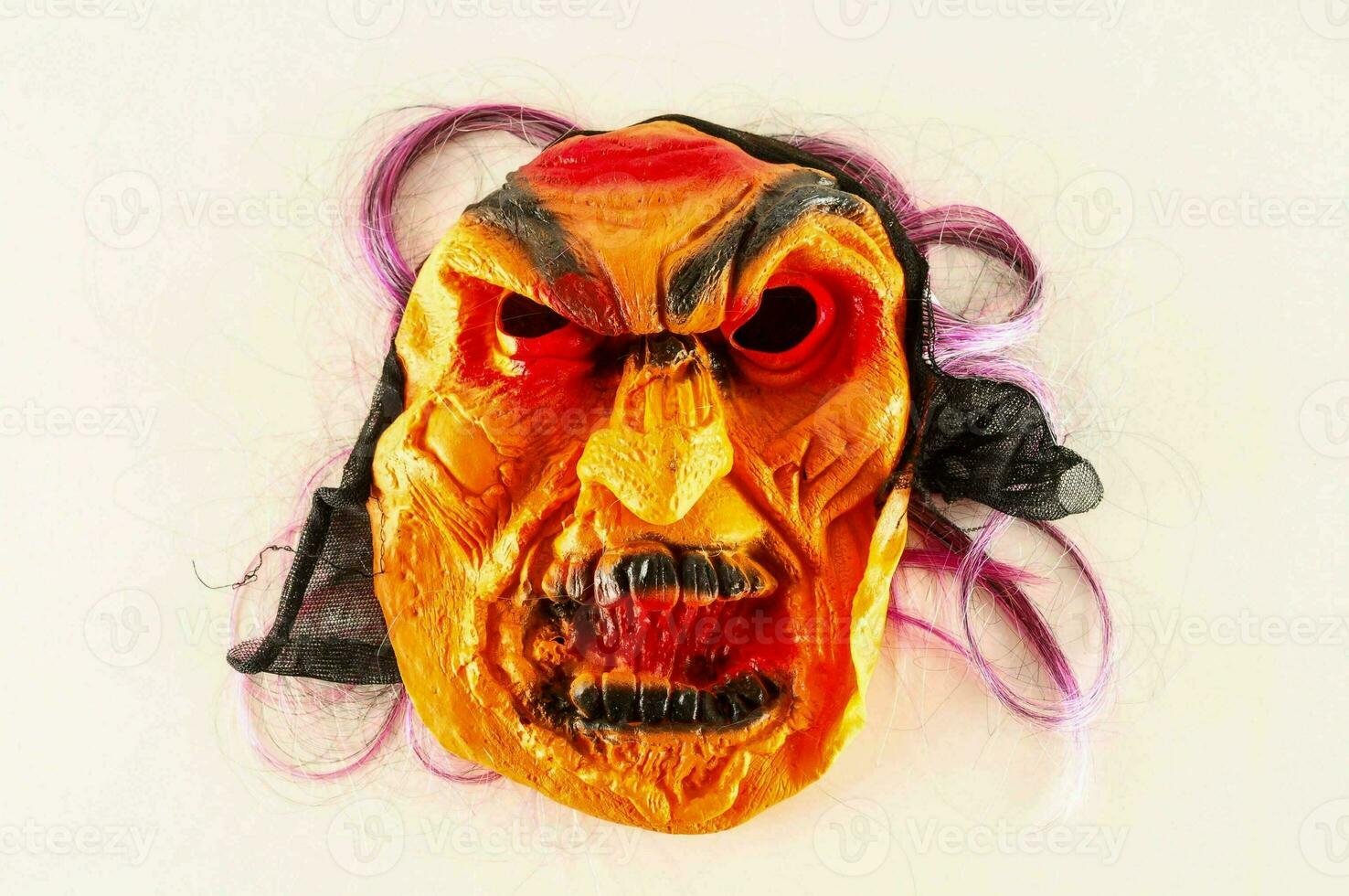 en halloween mask med lila hår och orange ögon foto