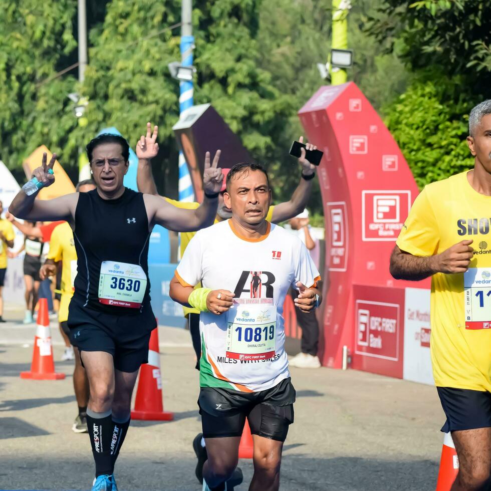 ny delhi, Indien - oktober 15 2023 - vedanta delhi halv maraton lopp efter covid i som maraton deltagarna handla om till korsa de Avsluta linje, delhi halv maraton 2023 foto