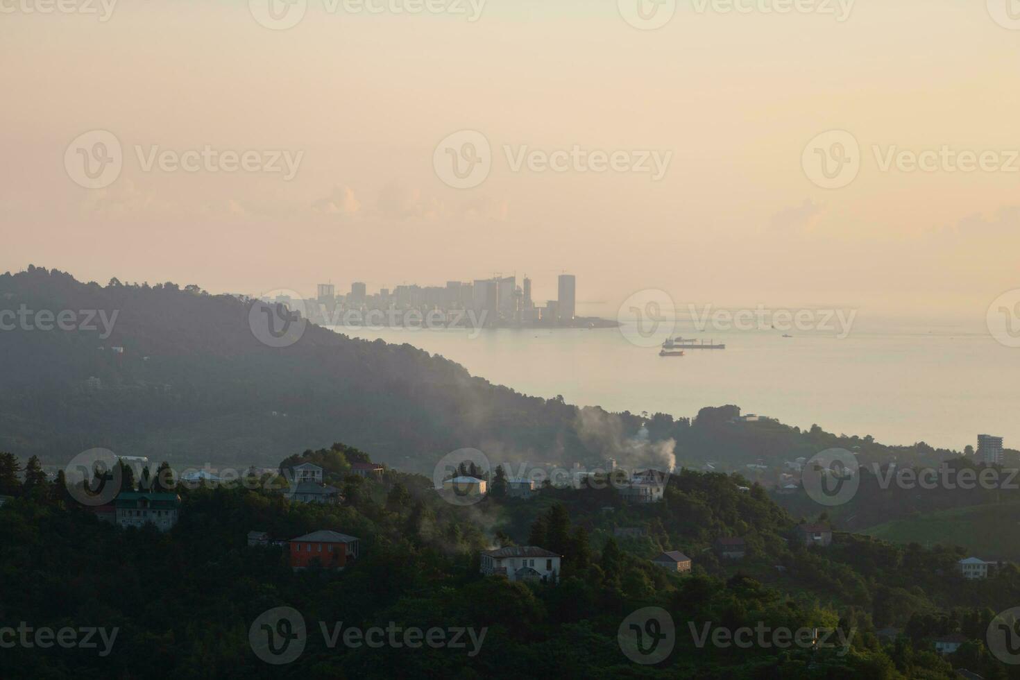 landskap av georgien. bergen och de hav på solnedgång med en panorama av de stad i de dimma. foto