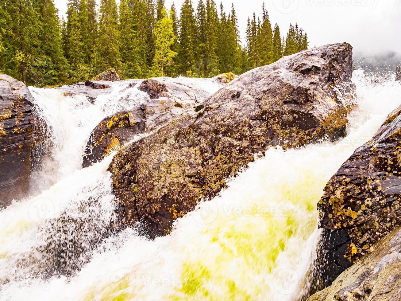 snabbt flödande flod vid rjukandefossen vattenfall, hemsedal, norge foto