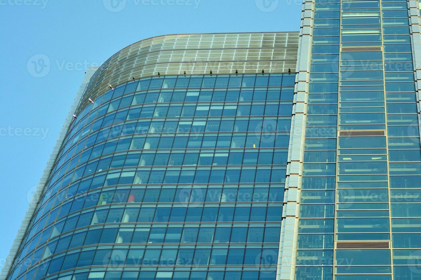 glas byggnad med transparent Fasad av de byggnad och blå himmel. strukturell glas vägg reflekterande blå himmel. abstrakt modern arkitektur fragment. samtida arkitektonisk bakgrund. foto