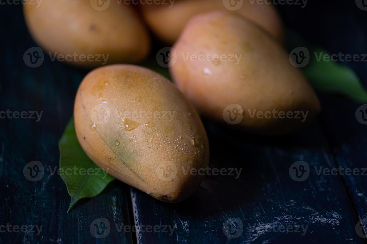 skär och färdig mango på en tallrik i en mörk miljö foto