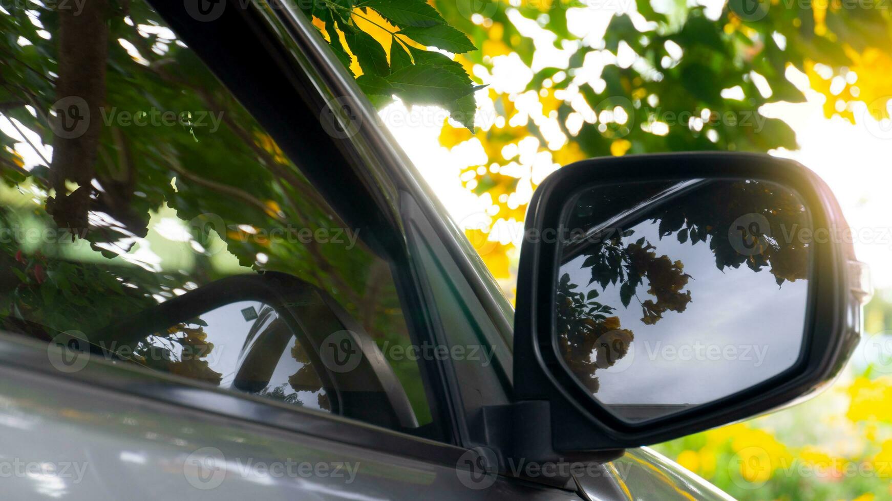 spegel vinge av bil parkering under av yello i de bris med solljus. foto
