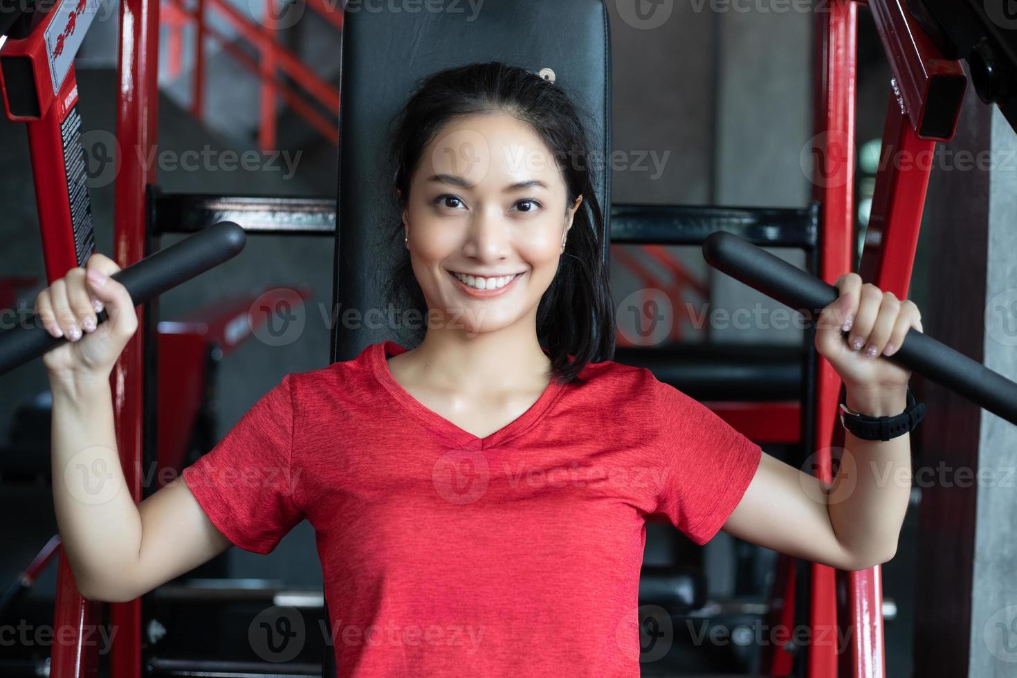 vacker muskulös fit kvinna som tränar byggande muskler och fitness kvinna gör övningar i gymmet. fitness - begreppet hälsosam livsstil foto