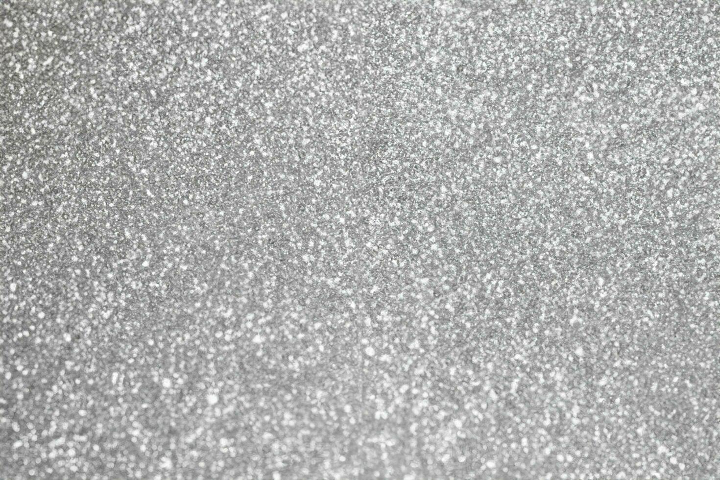 abstrakt fläck silver- glitter gnistra defocused bokeh ljus bakgrund foto