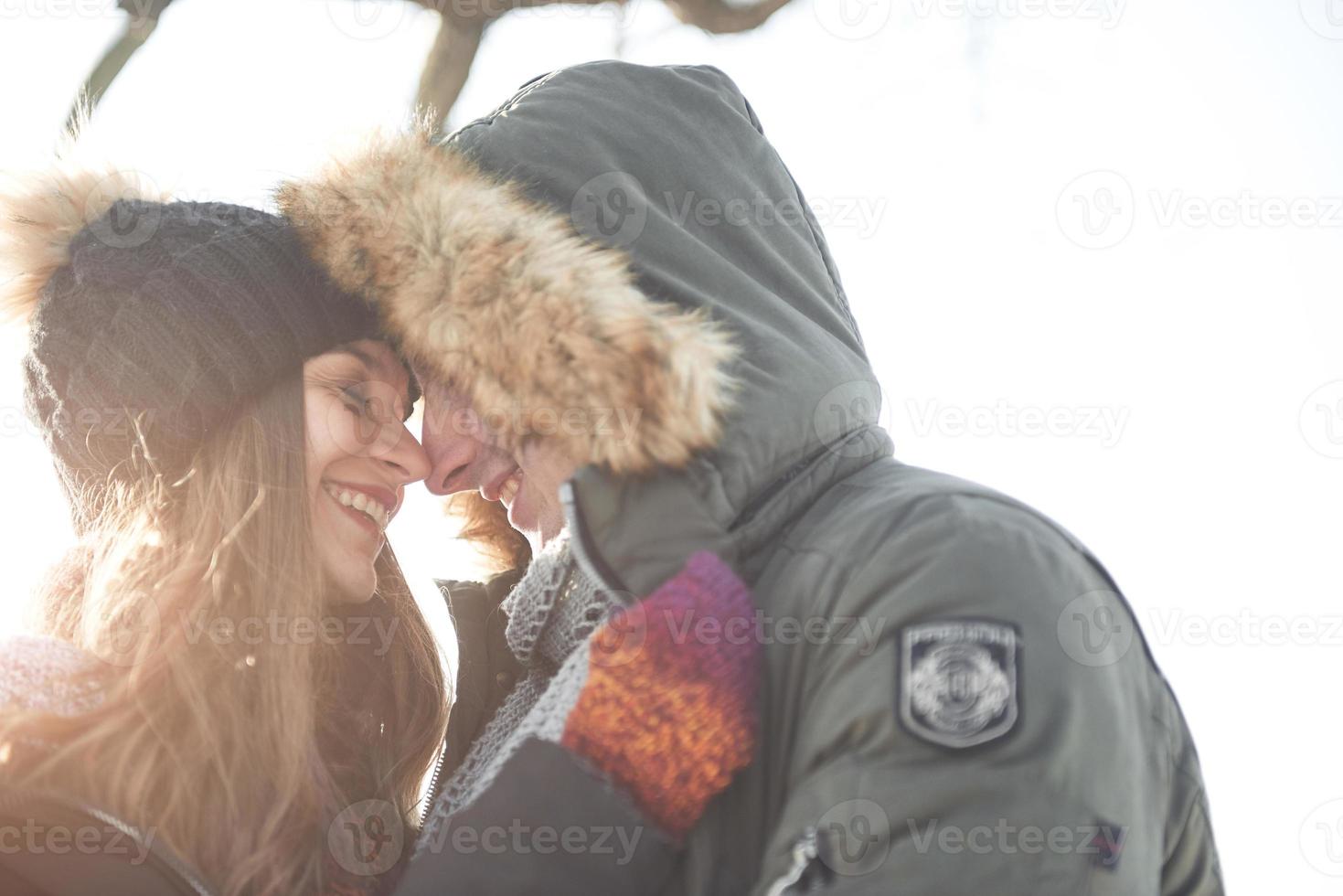 lyckligt ungt par i vinterparken som har kul. familj utomhus. foto
