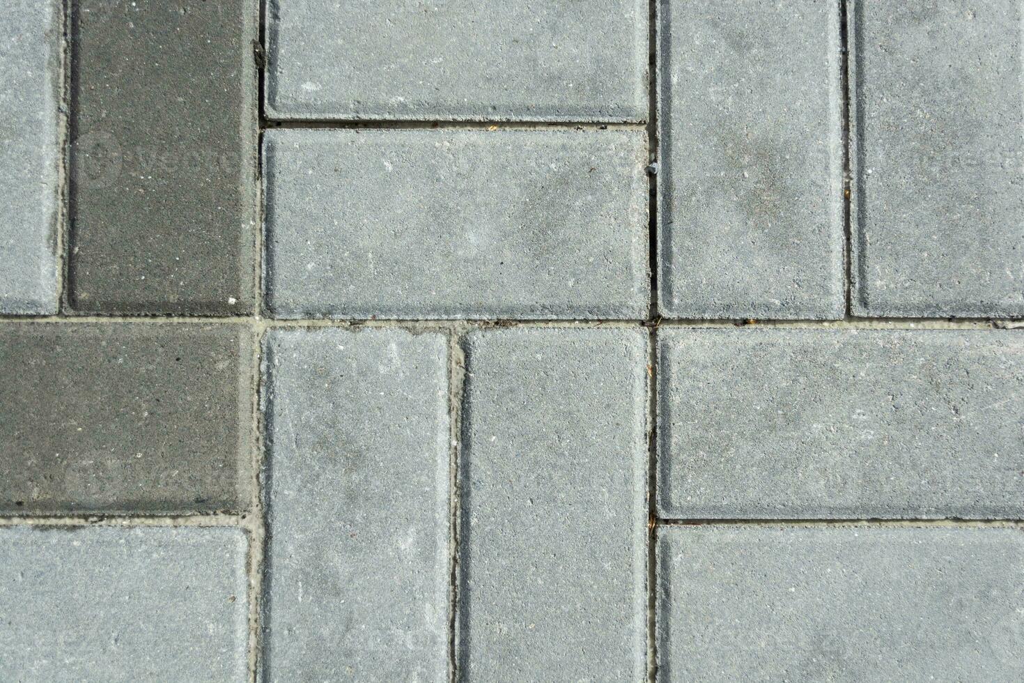 grå betong stenläggning plattor. textur av grå stenläggning plattor. foto