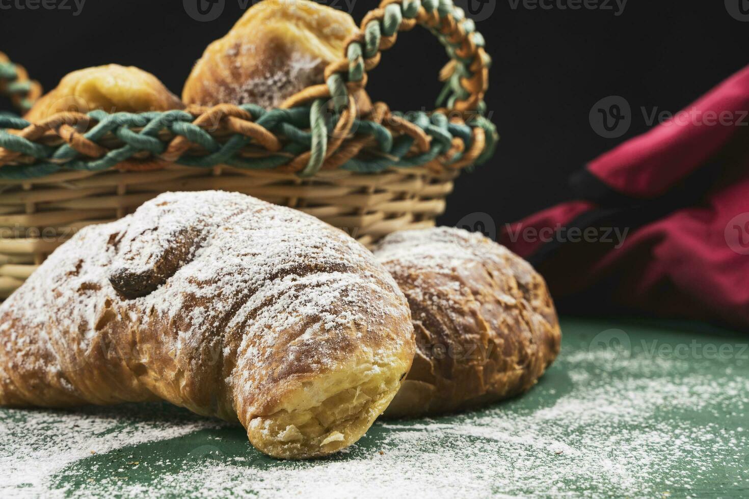 nyligen bakad croissanter med pulveriserad socker på en rustik tabell foto