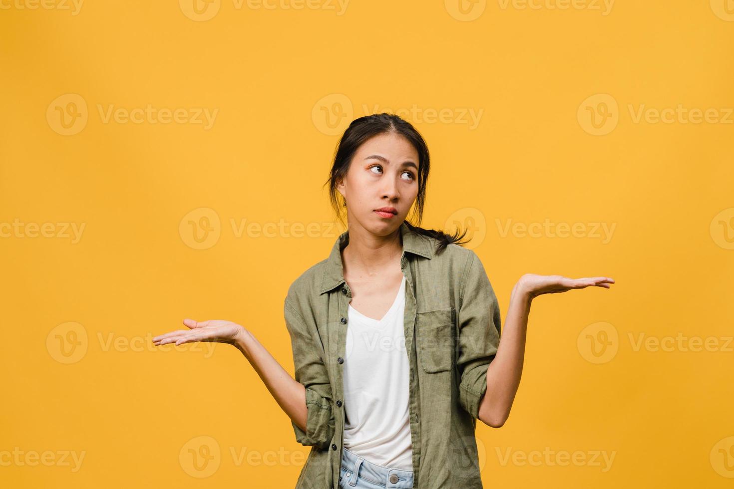 porträtt av ung asiatisk dam med negativt uttryck, upphetsad skrik, gråtande emotionell arg i vardagskläder isolerad på gul bakgrund med tomt kopieringsutrymme. ansiktsuttryck koncept. foto