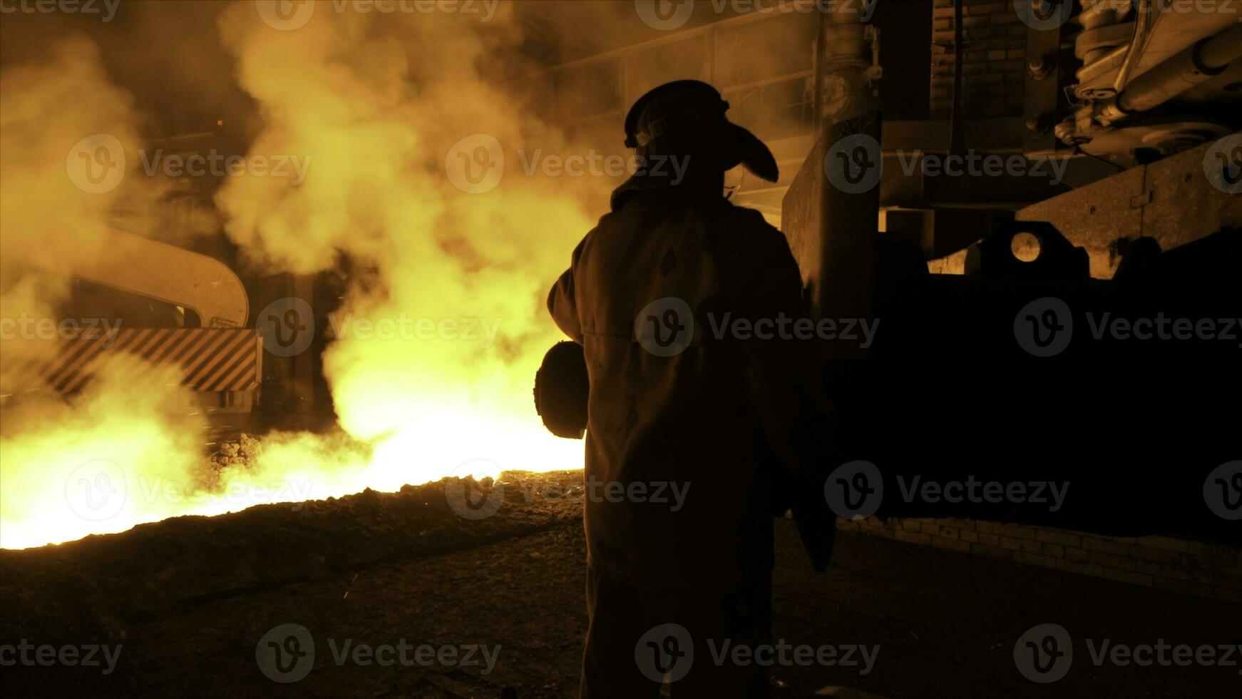 metallurg arbetstagare i skyddande enhetlig på de stål växt kontrollerande varm smält metall häller bearbeta. man arbetssätt i tung industri. foto