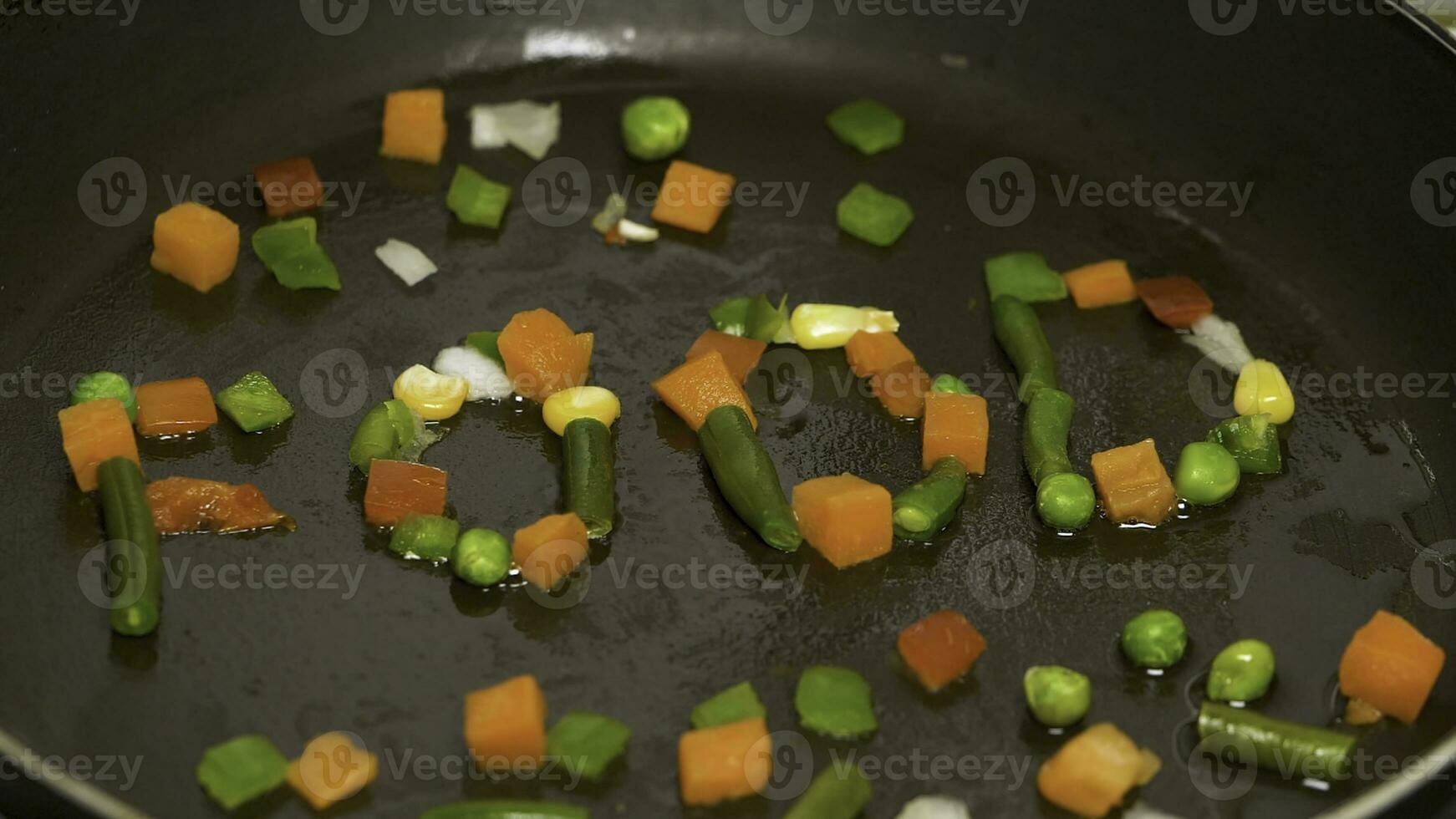 hackad grönsaker i de panorera är samlade in i de ord mat. Vispa friterad grönsaker i de panorera. grönsaker flygande mitten luft, varelse vänt från en fräsning panorera. vegetarian äter framställning grönsaker måltid foto