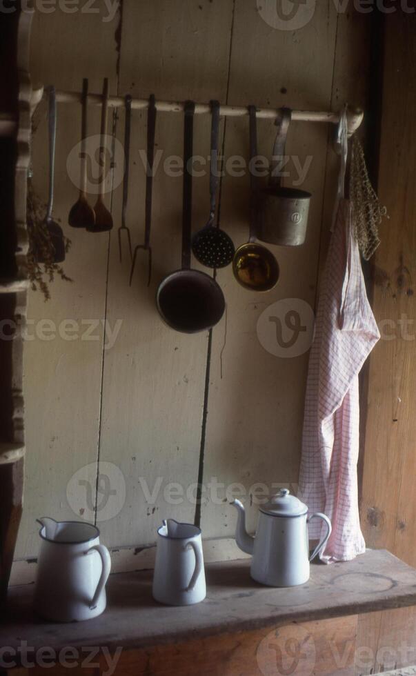 en hylla med kastruller och kokkärl hängande på den foto