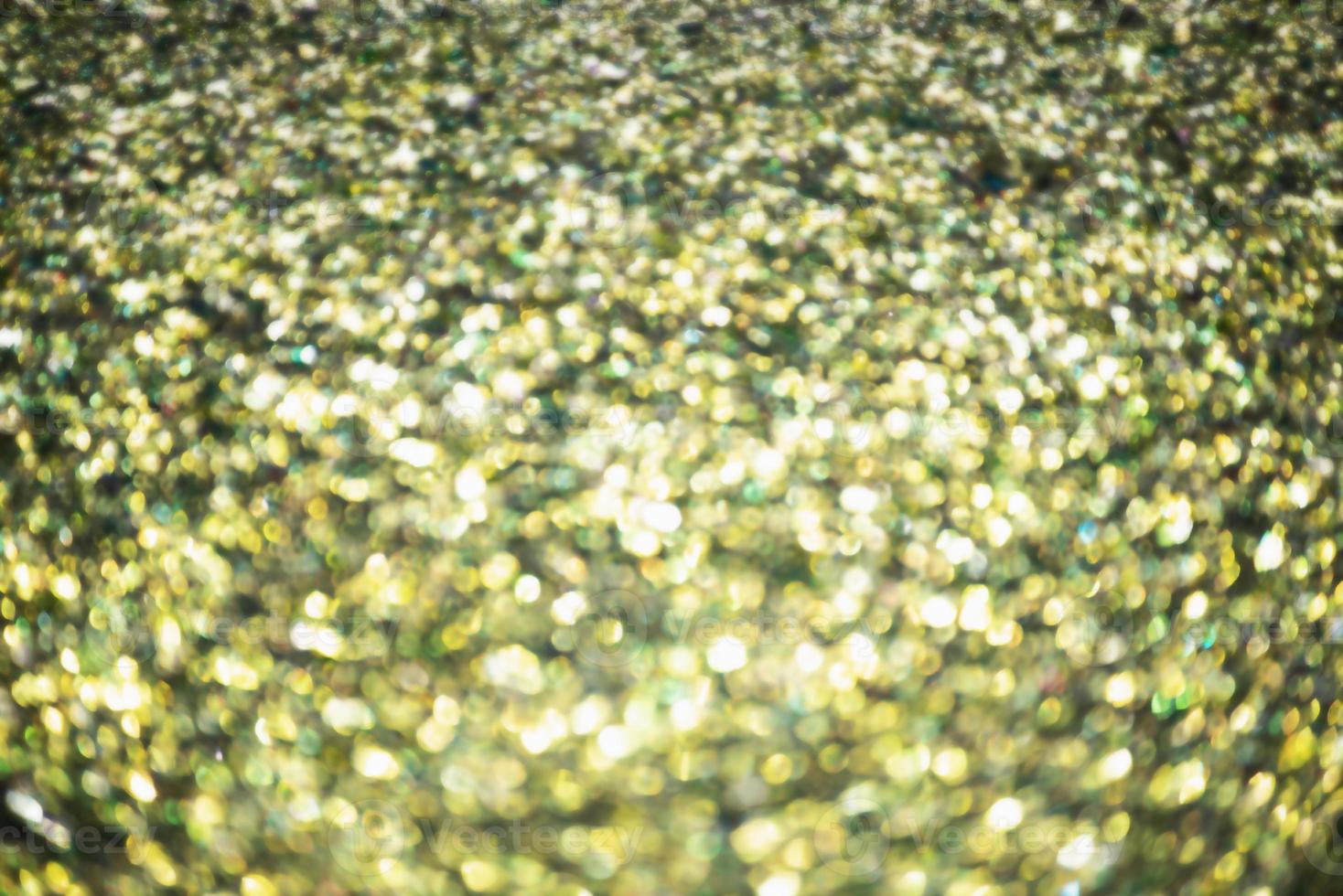 defocus ljus gyllene julfärg. glitter bakgrund, nytt år. foto