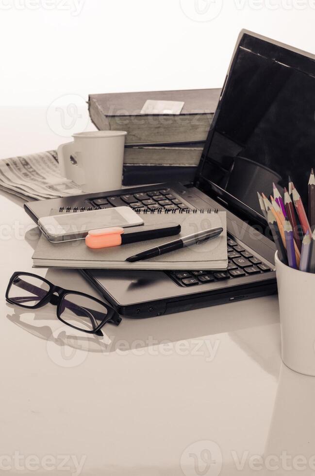 kontor skrivbord med bärbar dator med företag Tillbehör och kopp av kaffe foto