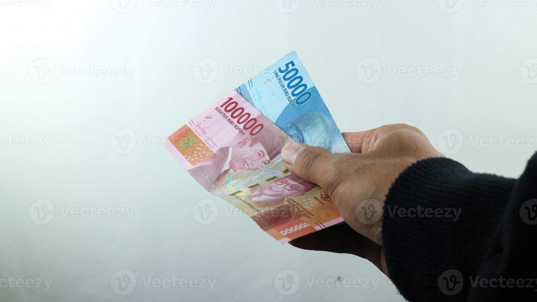 hand håll pengar rupiah, transaktion begrepp, finansiell begrepp foto