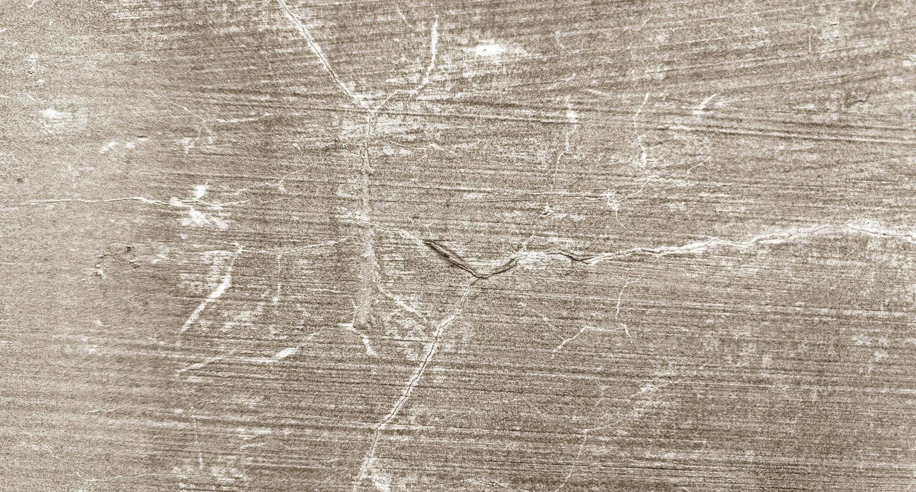grå sprucken cement textur för bakgrund. vägg repor foto